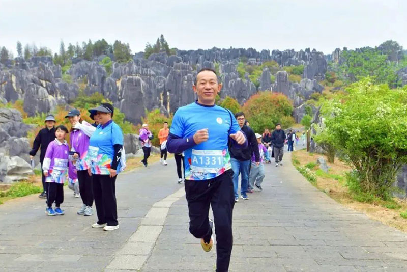 在石林风景区内进行的“穿梭石林奇境”健步走活动和“探秘石林奇境”亲子定向赛上，参与者手持活动打卡地图，穿梭在石峰间，打卡石林胜景、遗产标志石、阿诗玛、火把石等核心地标，用脚步丈量自然奇观，让亲子欢笑融入自然诗意。图片来源：昆明发布